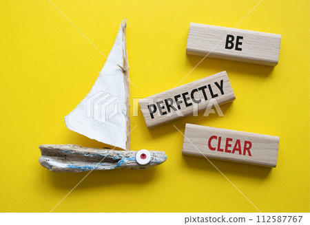 Be perfectly clear symbol. Concept words Be perfectly clear on wooden blocks. Beautiful yellow background with boat. Business and Be perfectly clear concept. Copy space 112587767