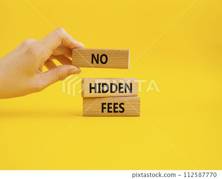 No hidden fees symbol. Concept word No hidden fees on wooden blocks. Businessman hand. Beautiful yellow background. Business and No hidden fees concept. Copy space 112587770