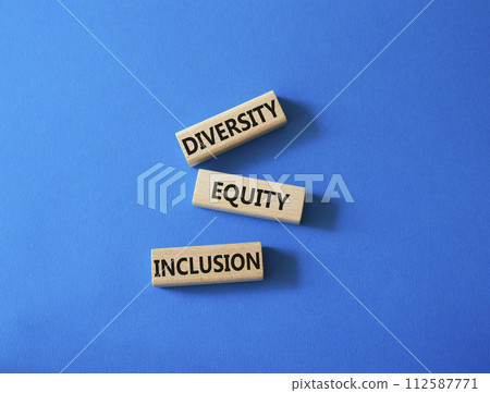 Diversity Equity Inclusion symbol. Concept words Diversity Equity Inclusion on wooden blocks. Beautiful blue background. Business and Diversity Equity Inclusion concept. Copy space 112587771