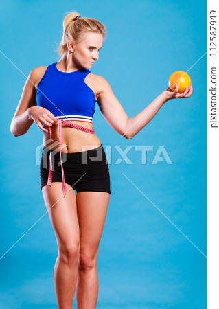 woman fit girl with measure tape and grapefruit 112587949