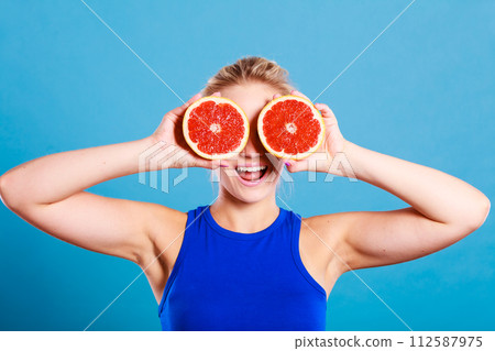 Woman holding grapefruit citrus fruit in hands Woman holding grapefruit citrus fruit in hands 112587975