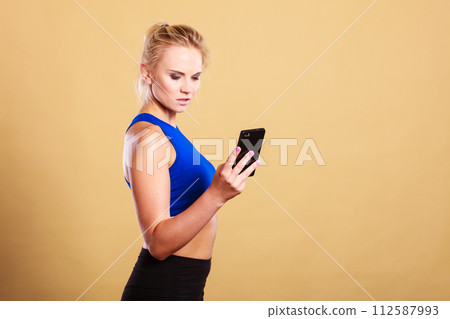 Sportswoman using mobile phone in the gym. 112587993