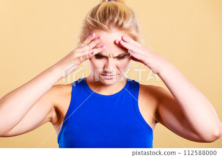fitness woman with headache migraine pain 112588000