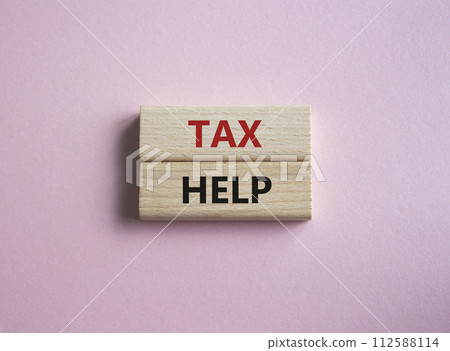 Tax Help symbol. Concept word Tax Help on wooden blocks. Beautiful pink background. Business and Tax Help concept. Copy space 112588114