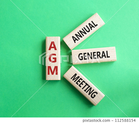 AGM - Annual general meeting symbol. Concept word AGM on wooden blocks. Beautiful green background. Business and AGM concept. Copy space. AGM - Annual general meeting symbol. Concept word AGM on wooden blocks. Beautiful green background. Business and AGM concept. Copy space. 112588154