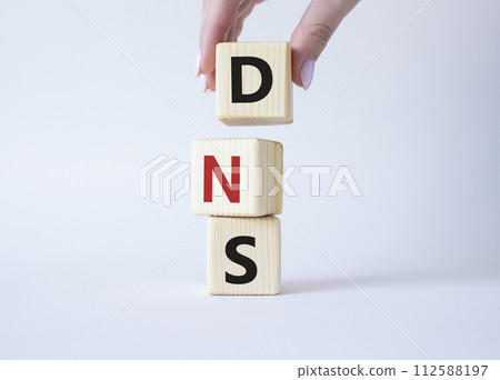 DNS -Domain Name Server - Consumer Price Index symbol. Concept word DNS on wooden cubes. Businessman hand. Beautiful white background. Business and DNS concept. Copy space. DNS -Domain Name Server - Consumer Price Index symbol. Concept word DNS on wooden cubes. Businessman hand. Beautiful white background. Business and DNS concept. Copy space. 112588197