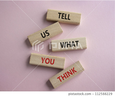 Tell us what you think symbol. Wooden blocks with words Tell us what you think. Beautiful pink background. Business and Tell us what you think concept. Copy space. 112588229