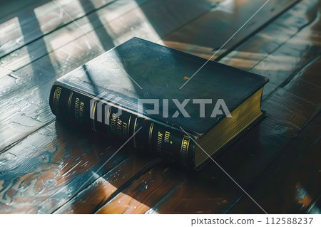 AI-generated content. A book, likely a Holy Bible, placed on top of a wooden table. 112588237