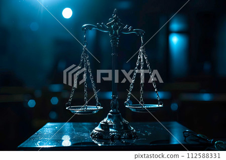 AI-generated content. Scales of justice sitting on a table in a dark court hall. 112588331