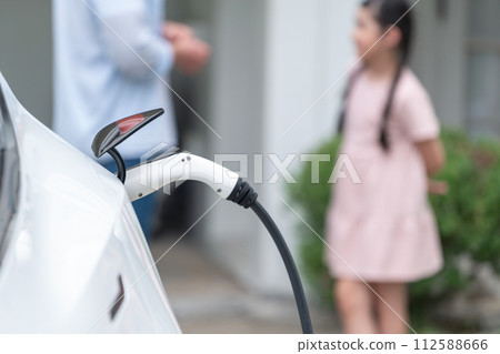 Focused electric vehicle recharging battery by home charging station. Synchronos 112588666