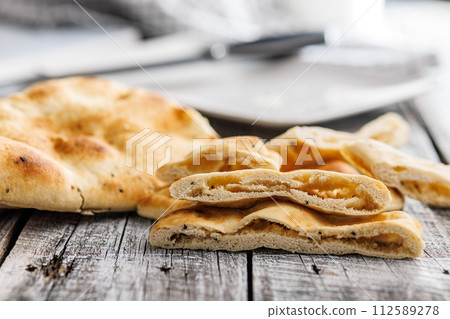 Freshly Baked Naan Bread on wooden table 112589278