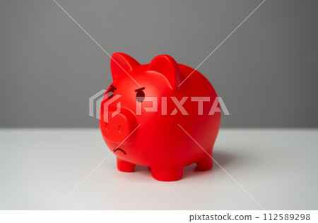 Angry red inflated piggy bank. Inflation is burning savings. Overheated financial market. Difficult economic conditions. Heavy burden on the budget, high expenses and the likelihood of bankruptcy. Angry red inflated piggy bank. Inflation is burning savings. Overheated financial market. Difficult economic conditions. Heavy burden on the budget, high expenses and the likelihood of bankruptcy. 112589298