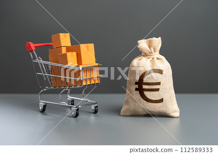 Shopping cart with boxes of goods and euro money bag. Purchasing power of buyers. Trade and retail. Taxes and income. Consumer prices. Import of products. Shopping cart with boxes of goods and euro money bag. Purchasing power of buyers. Trade and retail. Taxes and income. Consumer prices. Import of products. 112589333