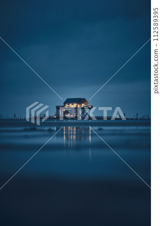 stilt house at sankt peter-ording germany at night 112589395