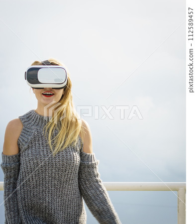 Woman wearing VR outside Woman wearing VR outside 112589457