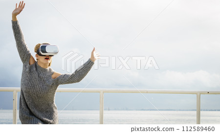 Woman wearing VR outside 112589460