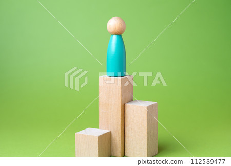 Man on a pedestal. Reach heights. Career success. Loneliness. Education and acquiring new skills. Reaching a high level of achievement, recognition 112589477