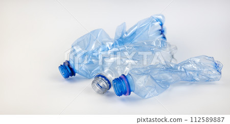 Crumpled used mineral water bottles on a white background. The concept of waste sorting. 112589887