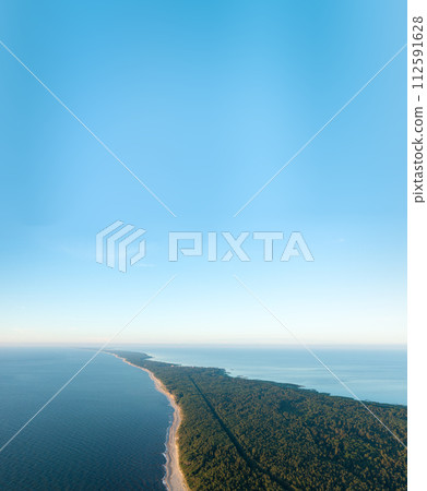 Curonian Spit wth Baltic sea coastline on sunset. Kurshskaya kosa national park near Zelenogradsk. Kaliningrad region. Aerial view 112591628