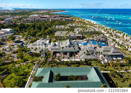 Tropical beach with resorts, palm trees and caribbean sea. Dominican Republic. Aerial view 112591864