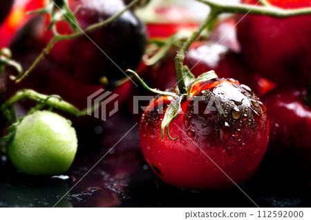 Crop of ripe indigo tomato on dark slate 112592000
