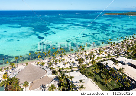 Tropical beach with resorts, palm trees and caribbean sea. Dominican Republic. Aerial view 112592029