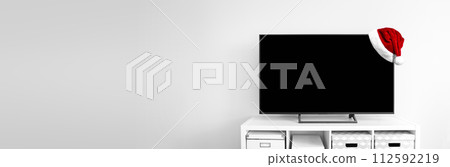 Santa Claus hat on Lcd tv on white shef at modern room interior 112592219