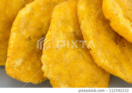Fried platanos on plate. Sliced and cooked tostones 112592232