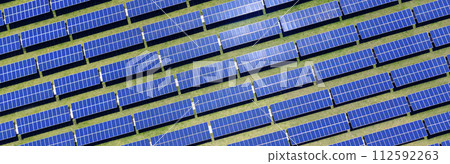 Blue solar panels. Alternative green clean source of energy. Aerial view. Long banner. Blue solar panels. Alternative green clean source of energy. Aerial view. Long banner. 112592263