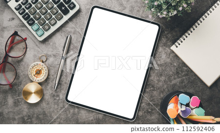 Tablet with blank screen display on office desk workplace. Top view flat lay 112592406