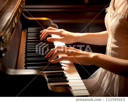 Closeup woman pianist hand playing the piano classical music instrument in the concert 112595023