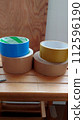 Duct tape on top of a wooden stepladder 112596190