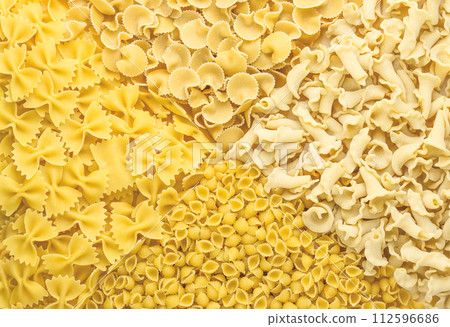 Background of different pasta types. Concept of culinary, food backgrounds. The view from the top. Background of different pasta types. Concept of culinary, food backgrounds. The view from the top. 112596686