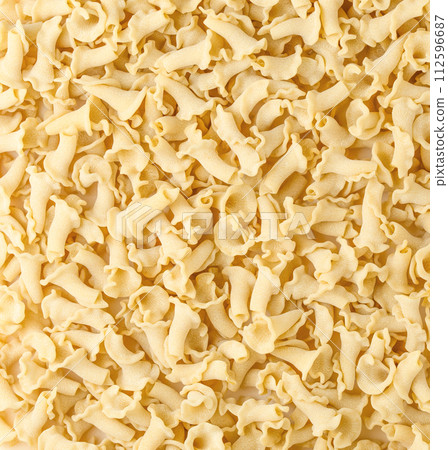 Uncooked Italian pasta Campanelle background. Gigli Pasta top view. High quality photo. 112596687