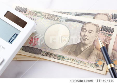 10,000 yen banknote with portrait of Yukichi Fukuzawa, calculator, and pen 112597450