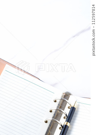 Image of doing desk work with a ring-type notebook Image of doing desk work with a ring-type notebook 112597814