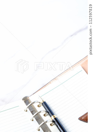 Image of doing desk work with a ring-type notebook Image of doing desk work with a ring-type notebook 112597819