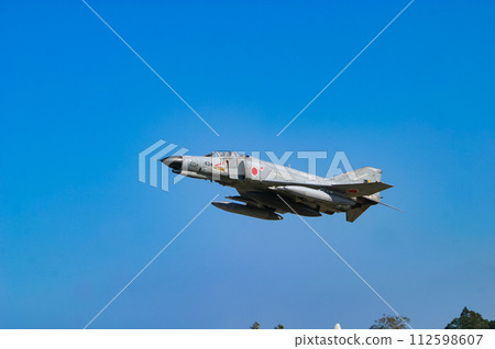 Air Self-Defense Force fighter aircraft F-4EJ Kai exhibiting flight display 112598607