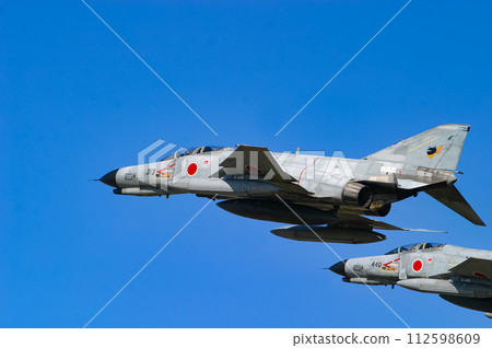 Air Self-Defense Force fighter aircraft F-4EJ Kai exhibiting flight display 112598609