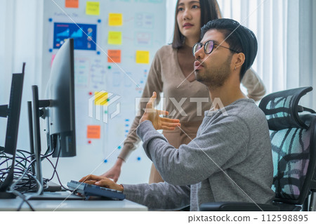 asian and Indian Developer team discussion feedback analysis coding data with software computer at office 112598895