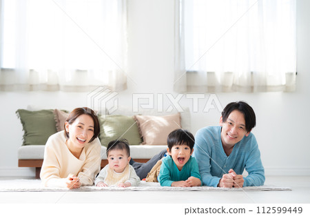 Family of four looking at camera 112599449