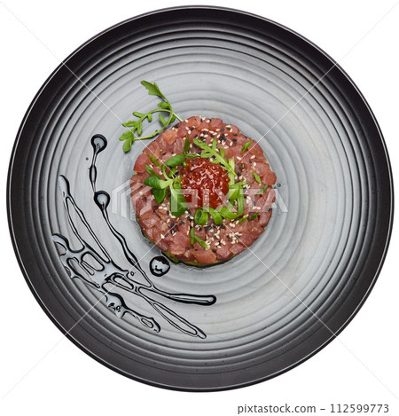 Tuna and avocado tartare on a dark ceramic plate Tuna and avocado tartare on a dark ceramic plate 112599773