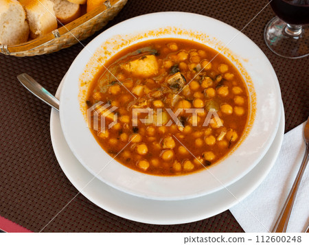 Stew boiled soup prepare of cod fillet, potatoes, chickpeas in tomato sauce. Stew boiled soup prepare of cod fillet, potatoes, chickpeas in tomato sauce. 112600248