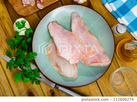 Fresh raw fillet of sea bass 112600274