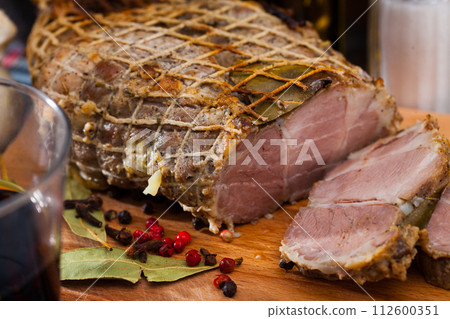 Appetizing pork ham with spices on a cutting board 112600351