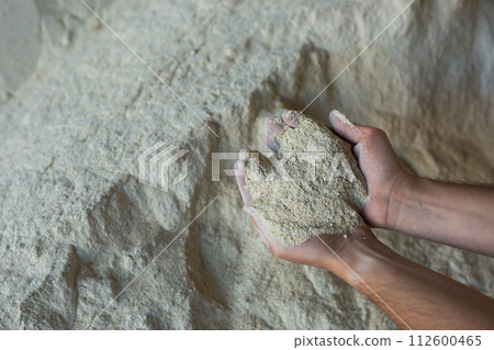 Close up of soy flour in hands of farmer. Feed for cows and calves 112600465