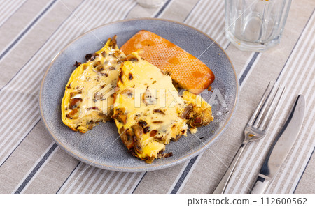 Homemade breakfast or brunch meal - Tasty mushroom omlette on plate, overhead view. 112600562