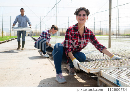 Female agriculturist working in warm house 112600784