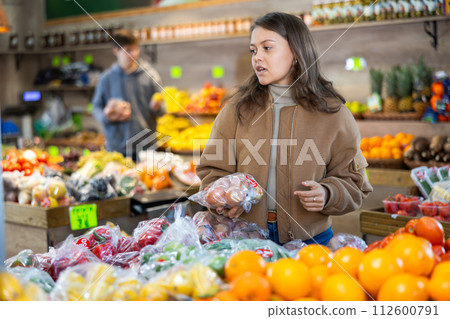 Young girl buying onions in grocery store Young girl buying onions in grocery store 112600791