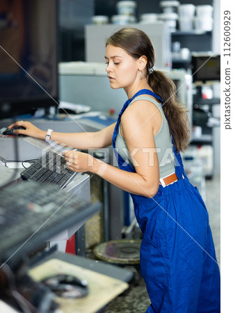 Warehouse girl employee look at computer monitor screen and check completeness of order for customer 112600929